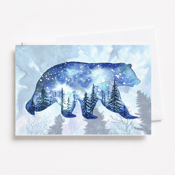 Indigo watercolor night sky full of stars above dark evergreens on a 5x7 folded blank card, shown with envelope